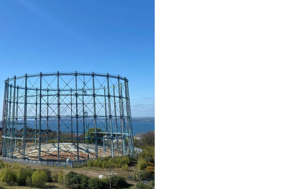 Close-up of the gasholder with the sea in the background.