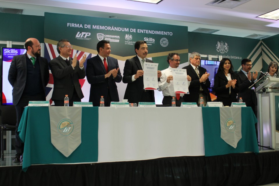 Representatives from Mexico and the UK hold the MoU in their hands to have photos taken