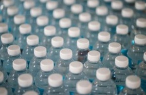 Photo of several plastic bottles in a row.