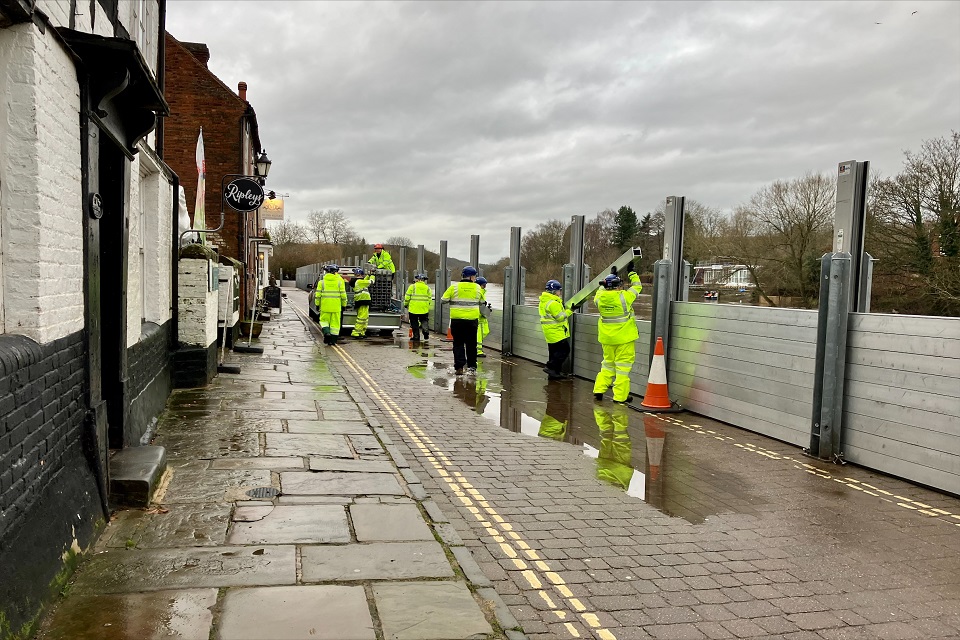 Environment Agency staff can be seen putting up flood barriers at Bewdley in Worcestershire