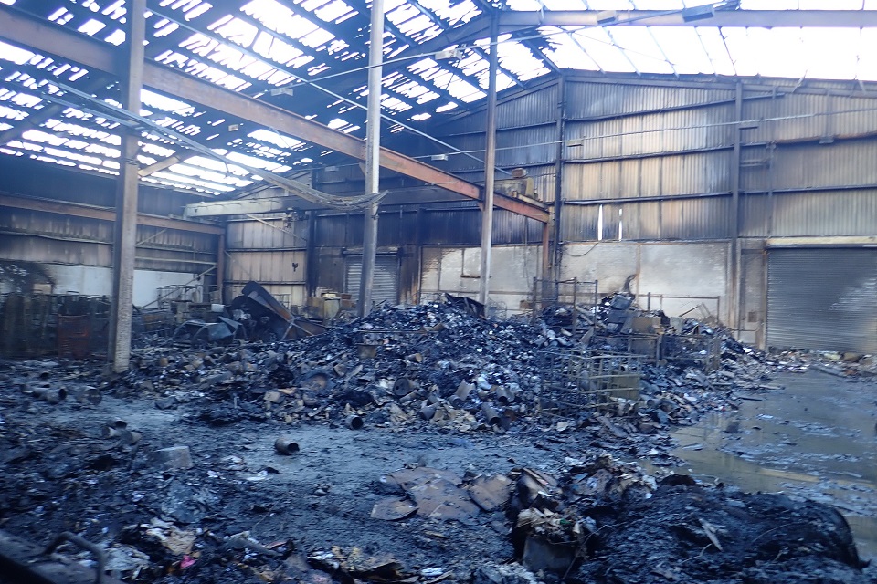 Images shows the aftermath of the fire at Shee recycling, with burned waste and building 