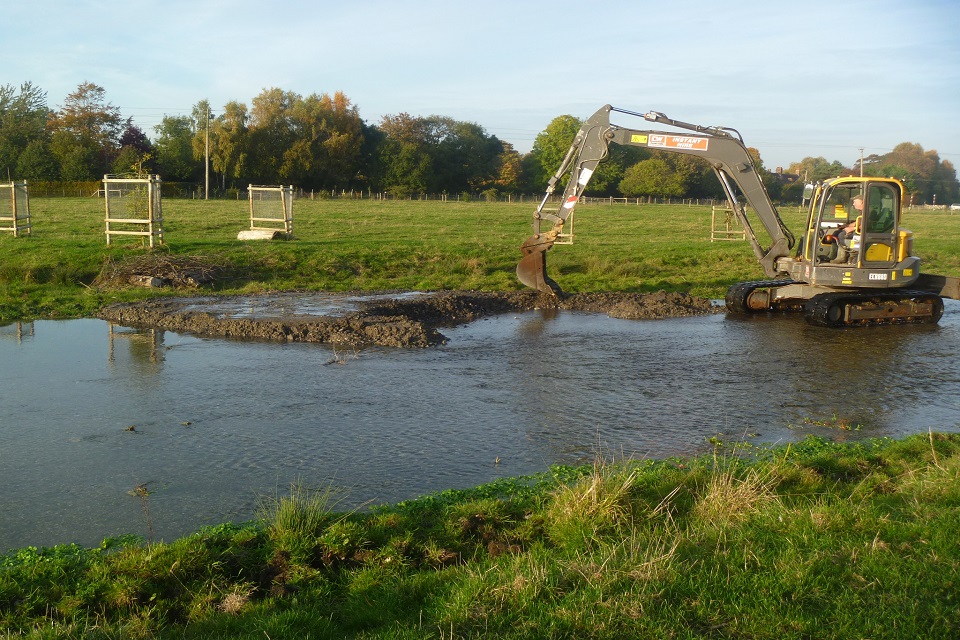 A mechanical digger can be seen changing the flow of the Little Stour