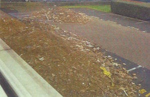 A massive pile of waste, most brick rubble and soils, can be seen from a office window