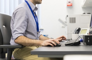 Close up of male doctor working at computer
