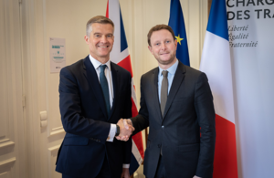 Secretary of State for Transport Mark Harper (left) with French counterpart Clément Beaune (right) shaking hands in front of the French national flag