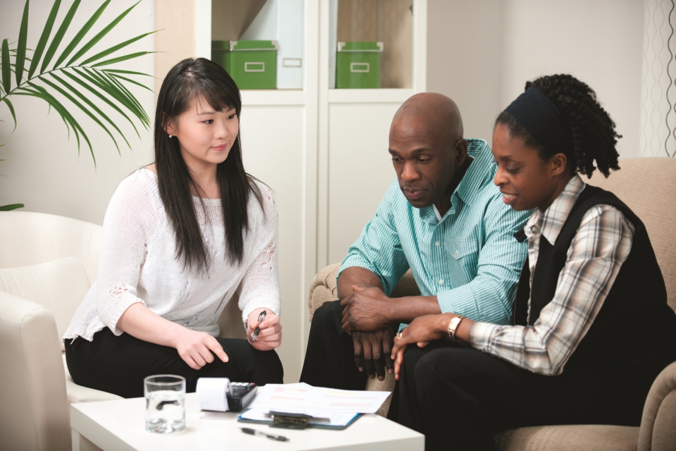 Group of three people looking over their energy bill