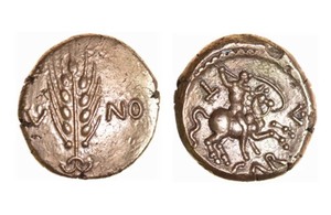 A photo of two bronze Roman coins with a white background