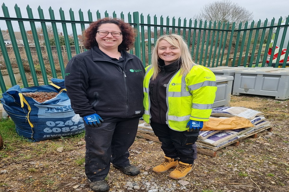 Environment Agency officers Maggie Byas and Vicky Bowen stand smiling at the camera
