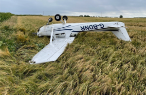 After hitting a hedge, the aircraft came to rest upside down.