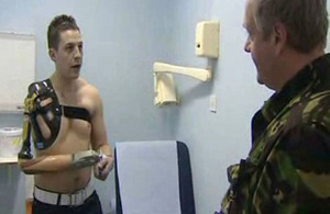 Corporal Andrew Garthwaite discusses his new prosthesis with an Army physician