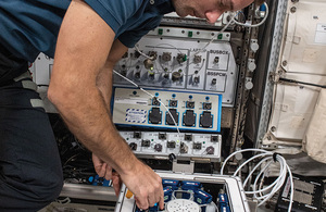 ESA astronaut Thomas Pesquet inserting 24 experiment units in the KUBIK incubator on the International Space Station.