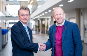 Professor Sir Peter Horby and Simon Earwicker shake hands