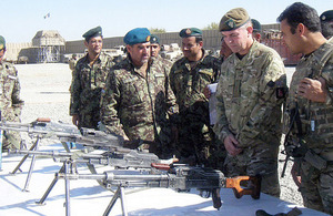 Brigadier General Mohammad Nasim shows Lieutenant Colonel Chris Davies the captured weaponry [Picture: Crown copyright]