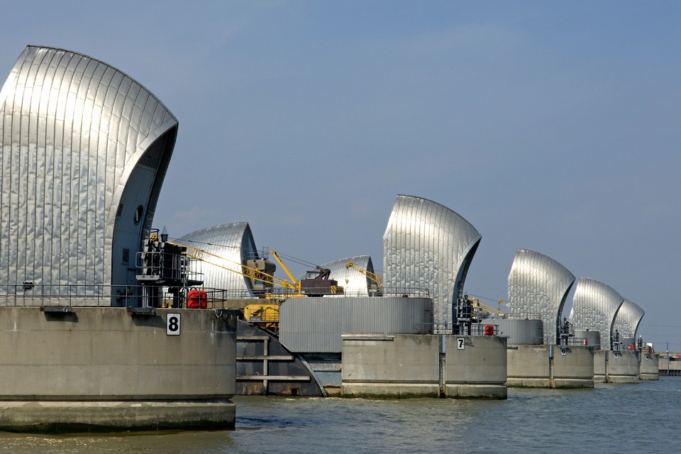 A view of 5 barrier gates across the River Thames.