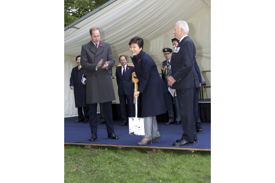 President Park Geun-hye of the Republic of Korea cuts the turf at the site of the new Korean War memorial in London