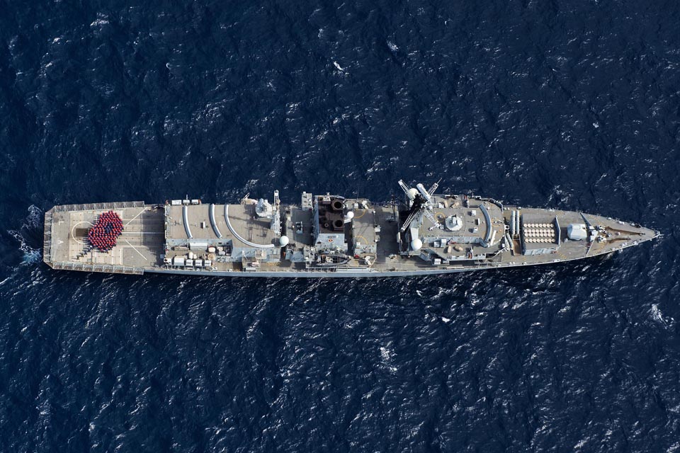 Sailors formed up in the shape of a bright red poppy