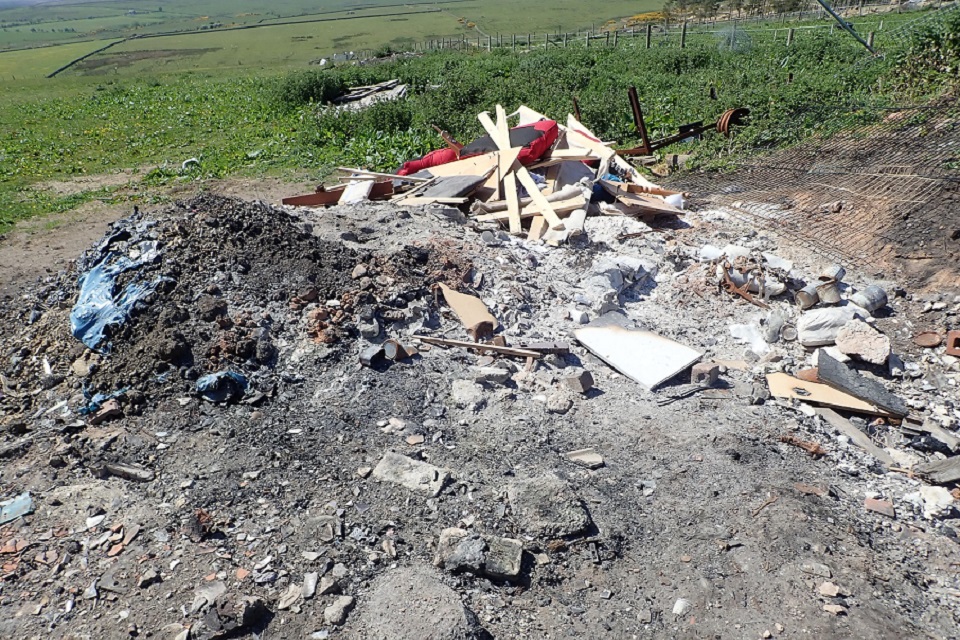 Image shows waste on site with evidence of burning 