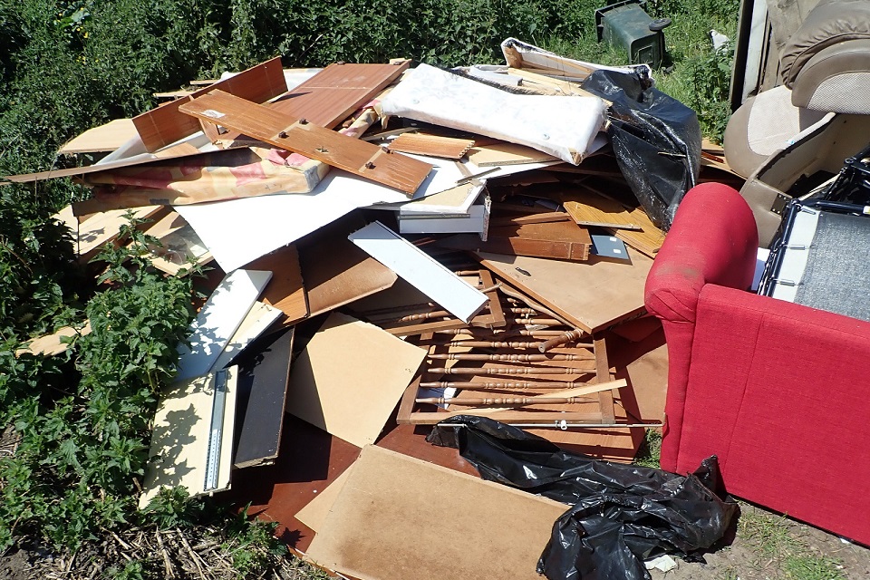 Image shows household waste including wood and a sofa dumped on the site 