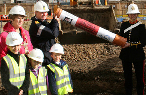 Councillor Lynne Stagg, Commodore Jeremy Rigby, Royal Marines musician April Burrow and local youngsters prepare to bury the time capsule [Picture: Crown copyright]