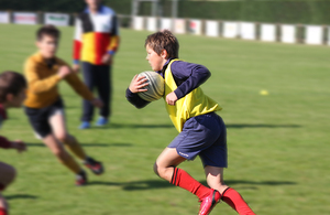 A photo of a young person playing rugby