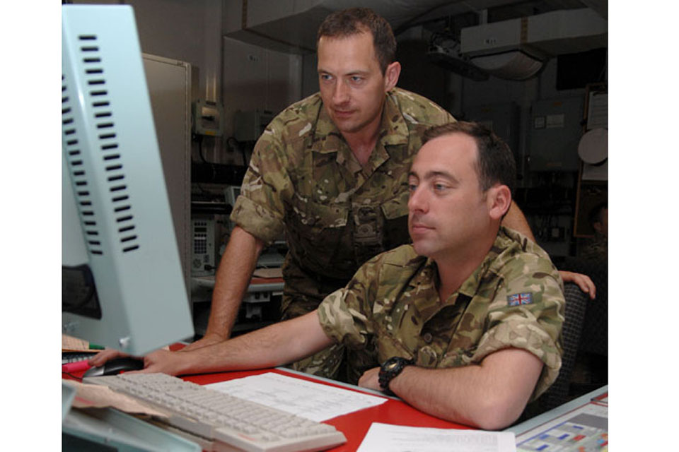 Royal Naval Reservists Lieutenant Richard Turley, from Liverpool's HMS Eaglet (left), and Lieutenant Alec Harper, from London's HMS President (right), support amphibious operations in the Combined Operations Room of assault ship HMS Albion