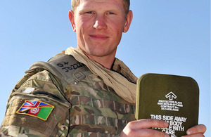 Gunner Carl Jordan holds up an armour plate