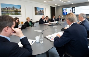 Members of the Net Zero Council around a conference table.
