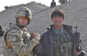 Regimental Sergeant Major McNally, 2nd Battalion The Royal Regiment of Scotland, congratulates his Afghan National Police counterpart