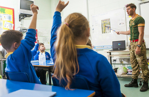 Instructor speaks to primary school children