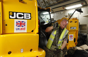 JCBs waiting to be unloaded from C-17 aircraft in Cebu