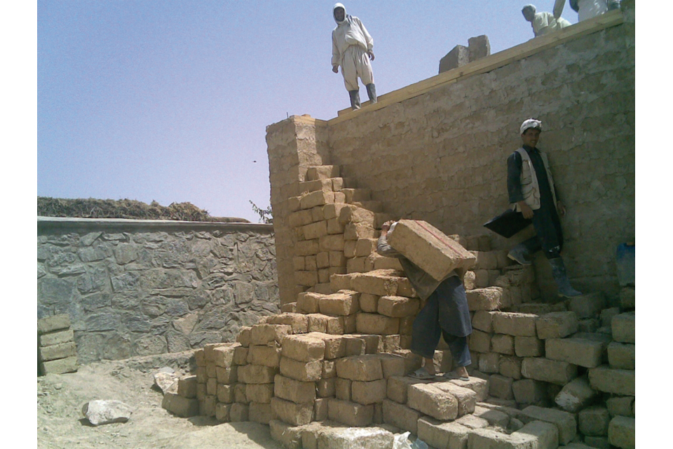 Afghan workers using traditional construction techniques