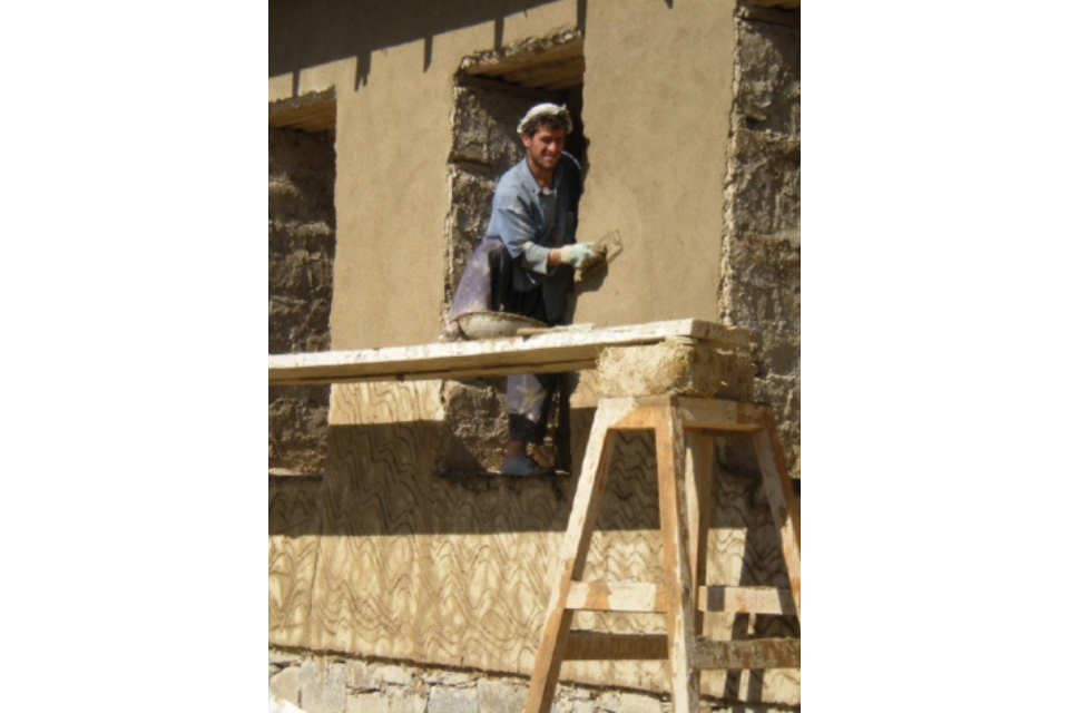 An Afghan worker using traditional construction techniques