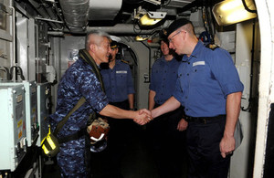 Captain Tanaka of JS ISE aboard HMS Illustrious amid ongoing UK and Japan support for relief efforts in the Philippines.