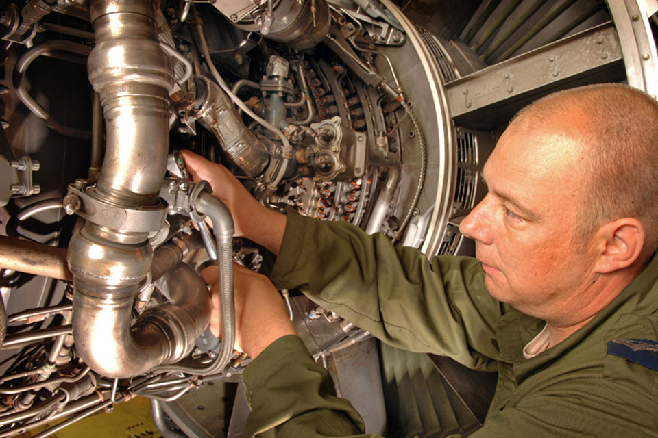 A Royal Air Force engineer works on the engine of an E-3D Sentry airborne early warning aircraft (stock image) 