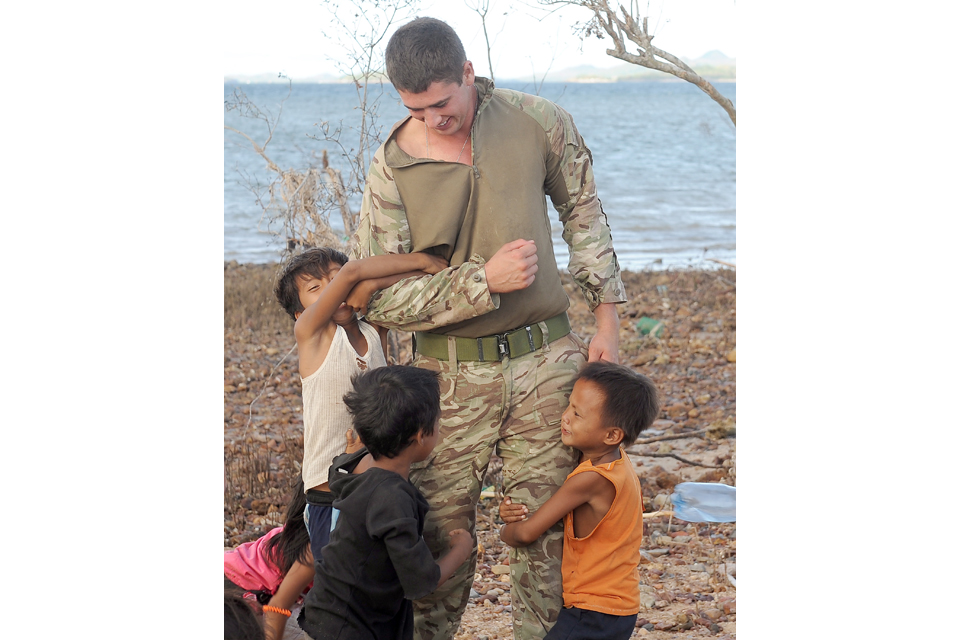 Local children with a Royal Marine