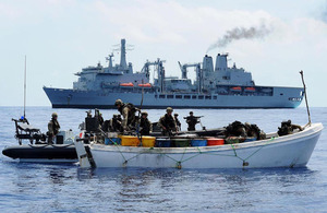 The pirate whaler being searched by the Royal Marines boarding team from RFA Fort Victoria, visible in the background