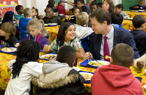 Deputy Prime Minister Nick Clegg eating lunch with students from Walnut Tree Walk Primary School.