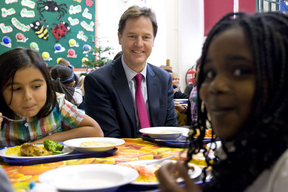 Deputy Prime Minister Nick Clegg eating lunch with students from Walnut Tree Walk Primary School.