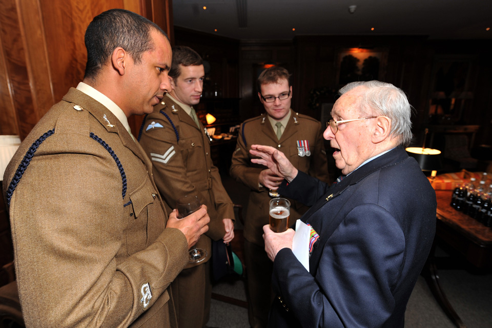 A veteran speaks with serving soldiers