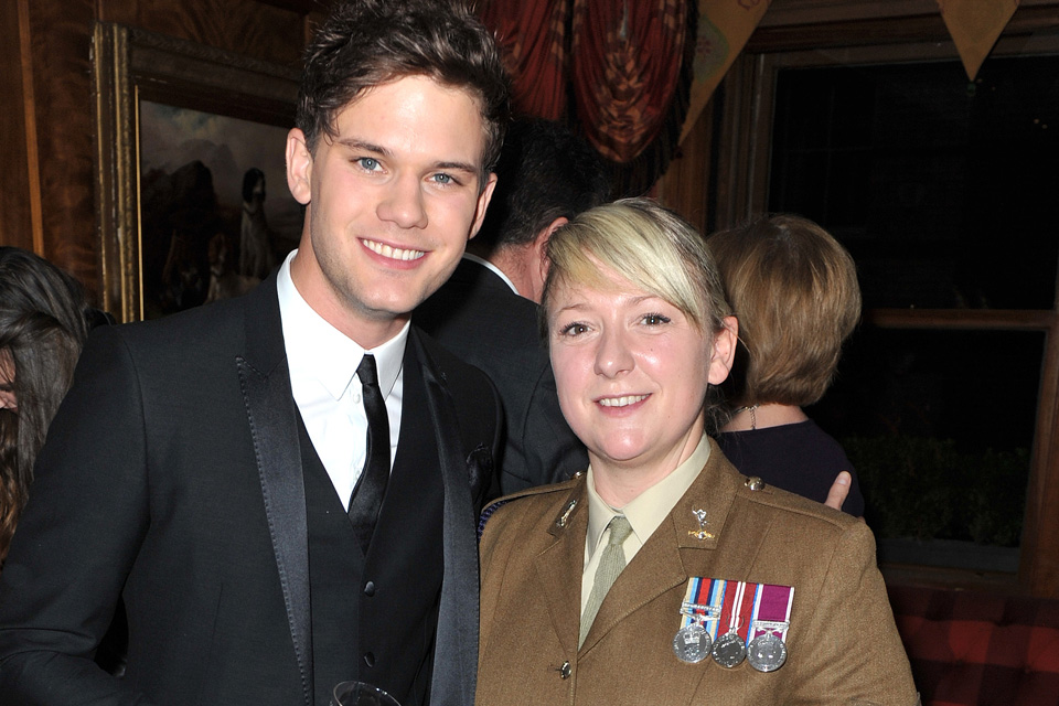 Jeremy Irvine with a serving member of the Royal Corps of Signals