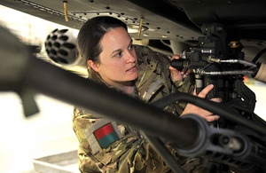 Aircraft engineering officer Captain Charlotte Joyce services an Apache helicopter's 30mm cannon [Picture: Sergeant Rupert Frere, Crown Copyright/MOD 2011]