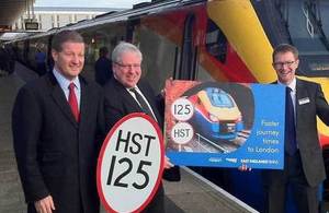 Patrick McLoughlin with officials in Derby