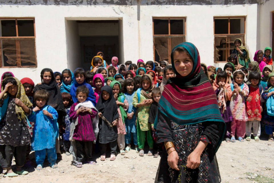 Afghan girls standing outside a school.