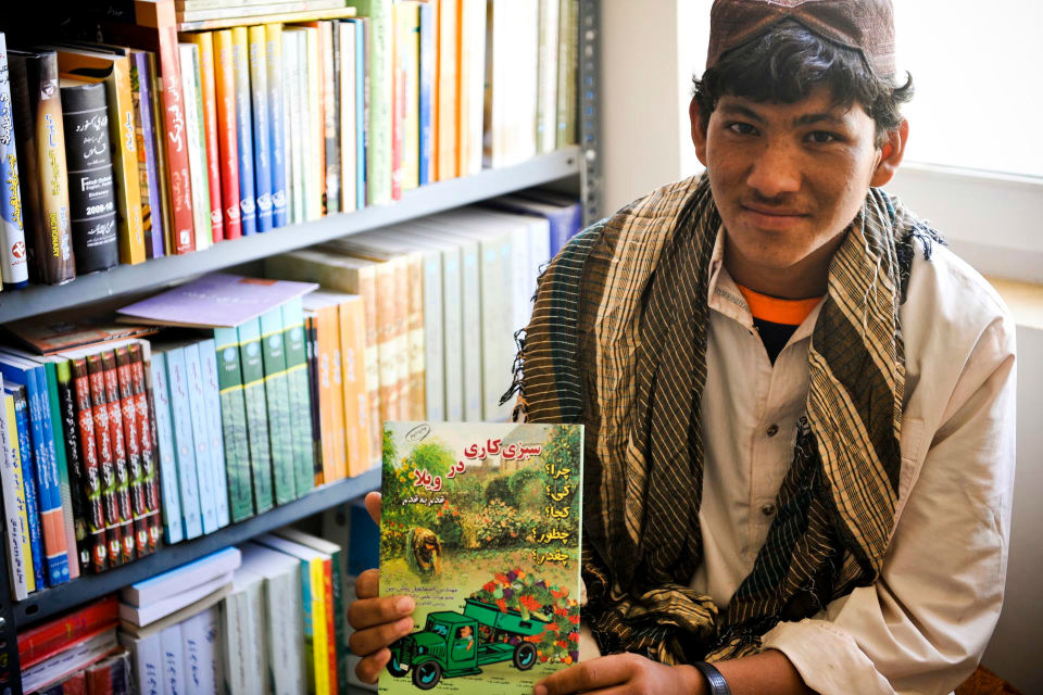 Afghan farmer in an agricultural college holding a book.