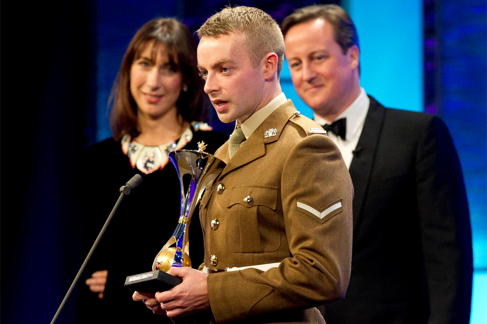 Samantha and David Cameron listen to Lance Corporal Keith Mallon's acceptance speech