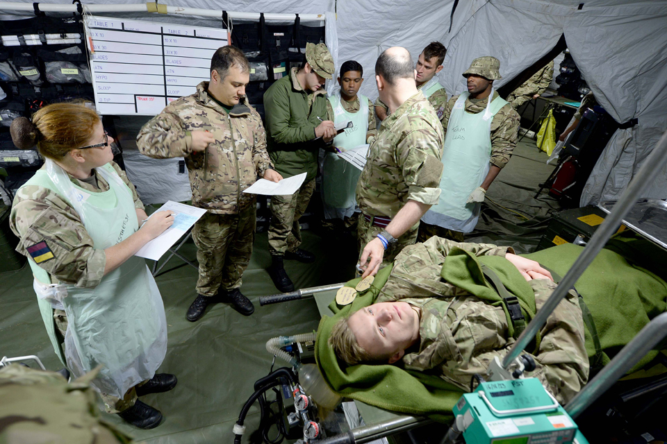 Medics confer prior to treating a simulated casualty 