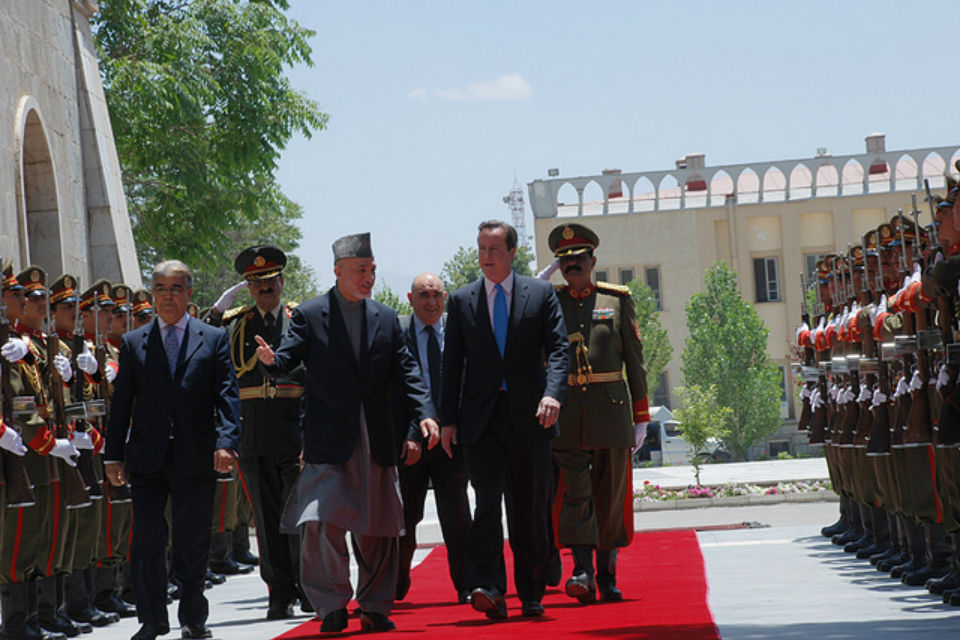 Prime Minister David Cameron and President Hamid Karzai of Afghanistan walking through a guard of honour.