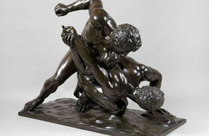 bronze statue of men wrestling