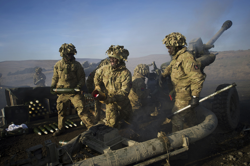 Soldiers of the Royal Artillery firing 105mm Light Guns