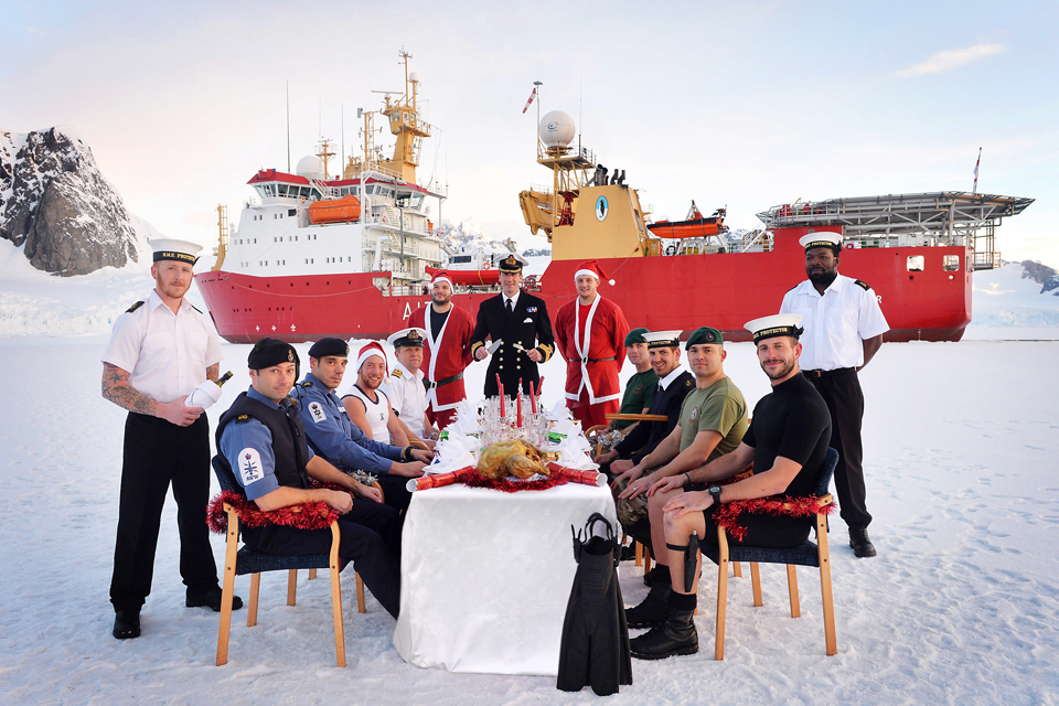 Captain Rhett Hatcher (centre) preparing to carve the turkey 